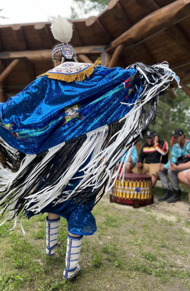 A chicken dancer performing in the Performance Arbour at the Indigenous Peoples Experience at Fort Edmonton Park.